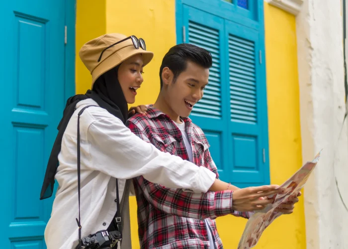 low-angle-view-couple-holding-map-standing-by-home-scaled